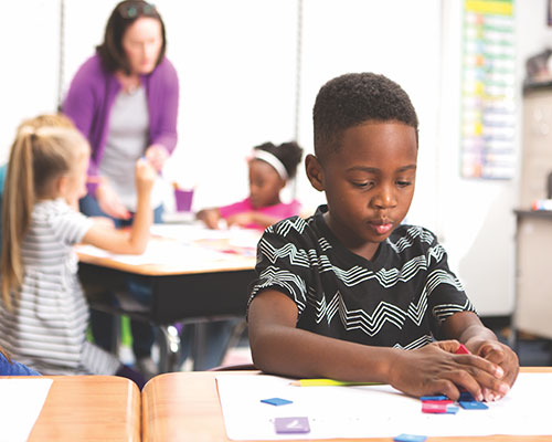 A young student working with manipulatives.